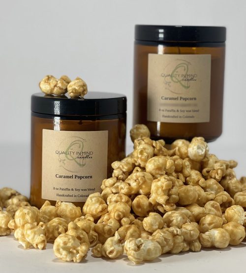 Caramel Popcorn Scented Candle displayed with a pile of caramel popcorn!