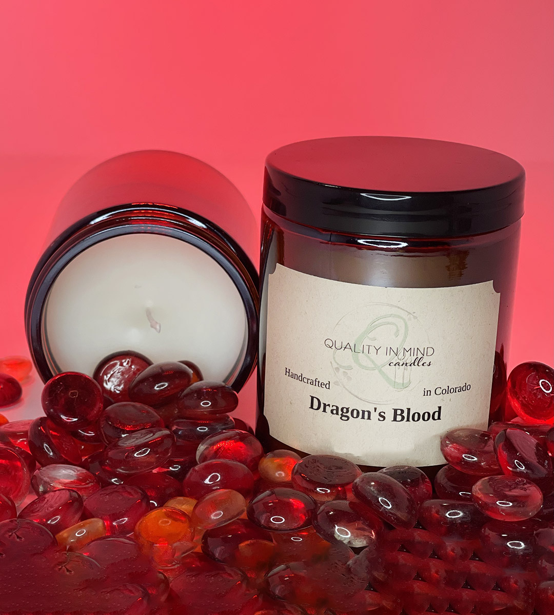 Candle in Dragon's Blood Scent surrounded by red stones