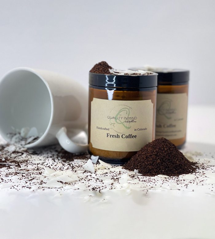Coffee Scented candle displayed with coffee grounds and coffee cup