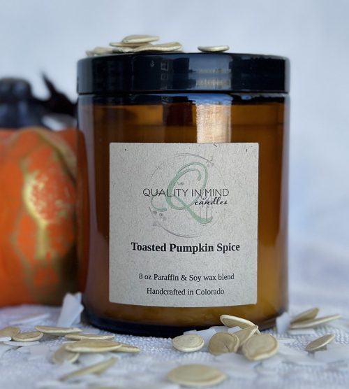 Toasted Pumpkin Spice Candle with pumpkin decoration and pumpkin seeds