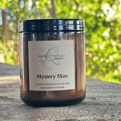 Mystery Man Handcrafted Candle in an outdoorsy setting